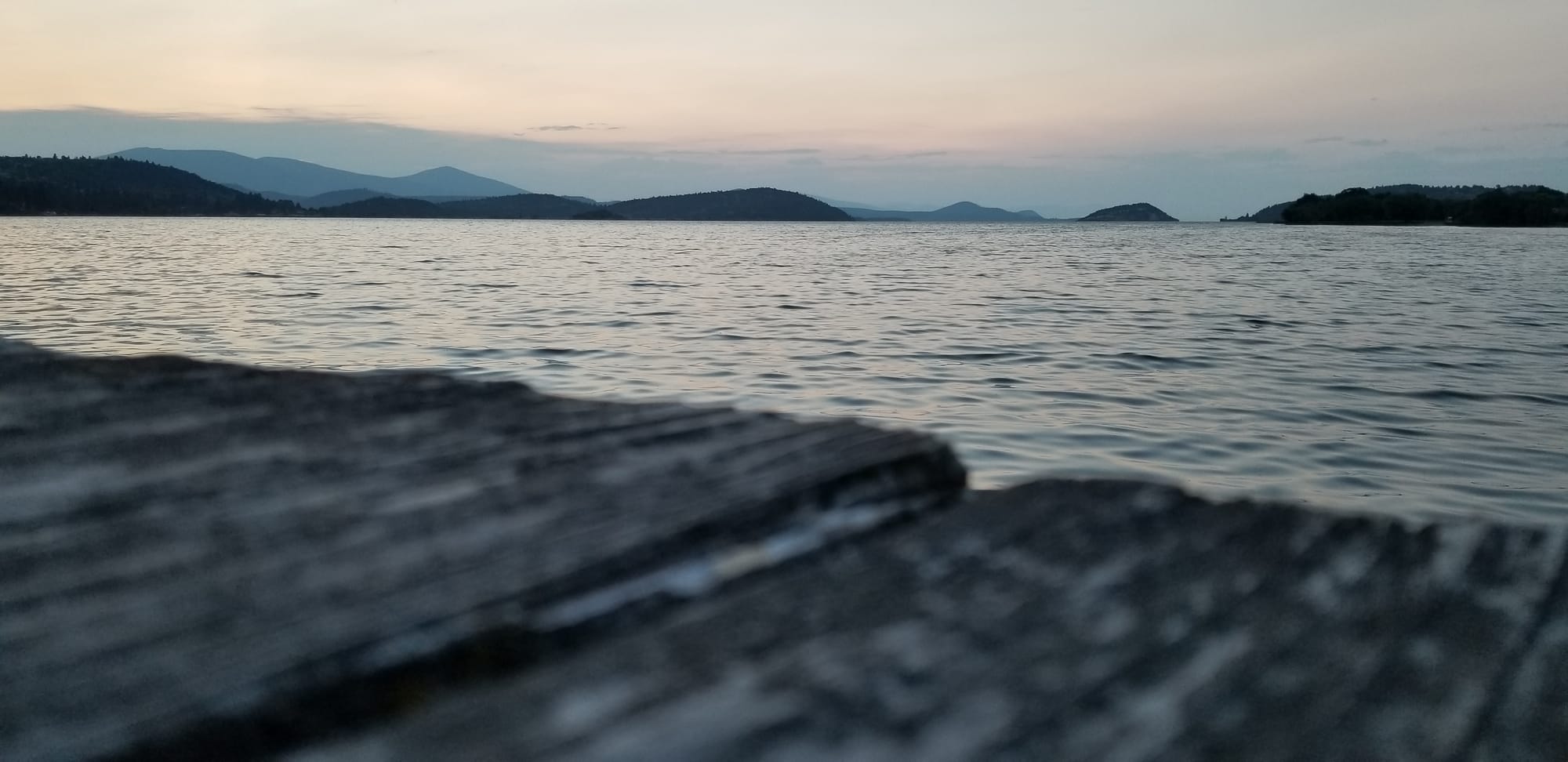 Boat dock overlooking a lake with mountains in the background